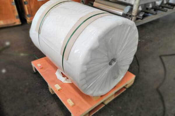 The aluminium foil jumbo roll is placed on a wooden pallet